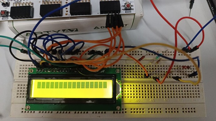 2.  TableFull wiring photo — LCD connected to Arty via breadboard, resistor divider visible